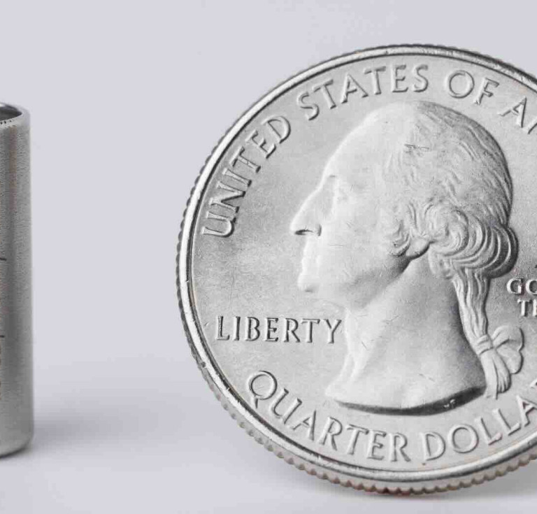 A one gigabyte synthetic DNA storage vial encoded with digital copies of Library collection items alongside a quarter 